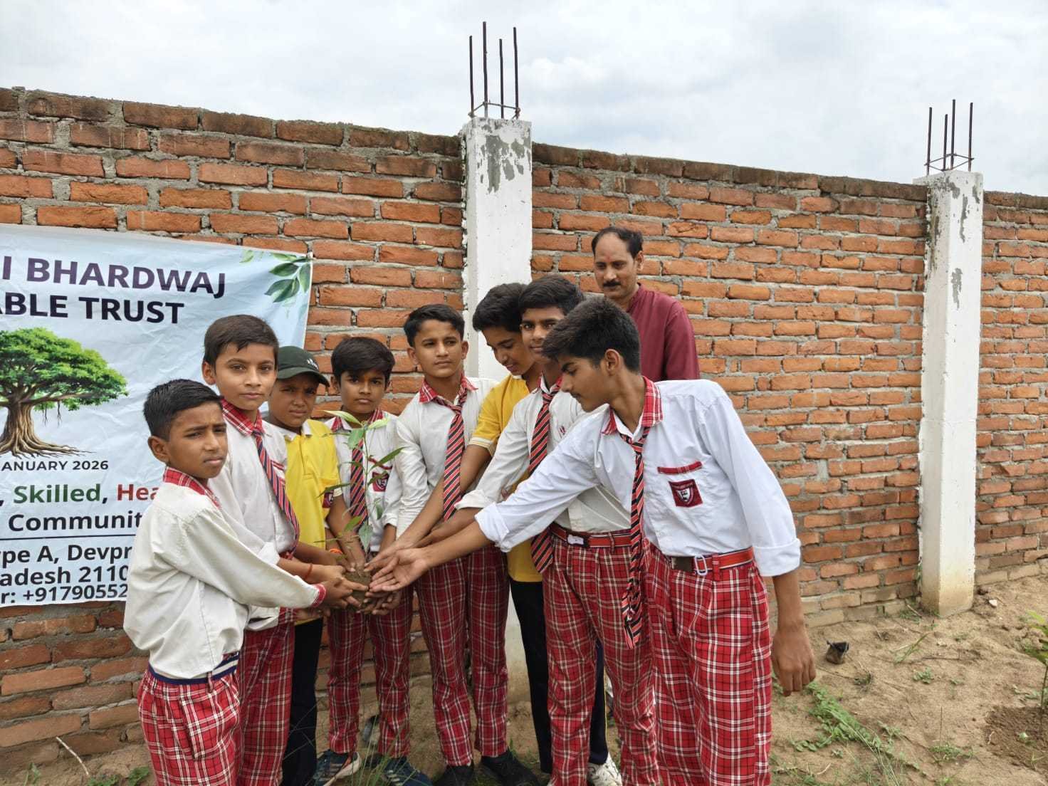 Tree plantation activity with the trust banner in the background